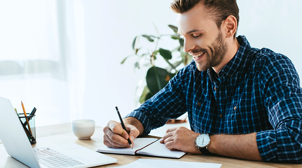 entrepreneur taking notes during a consulting call